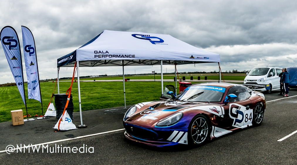 Gala Performance Ginetta beneath its paddock tent on a grey English race day.