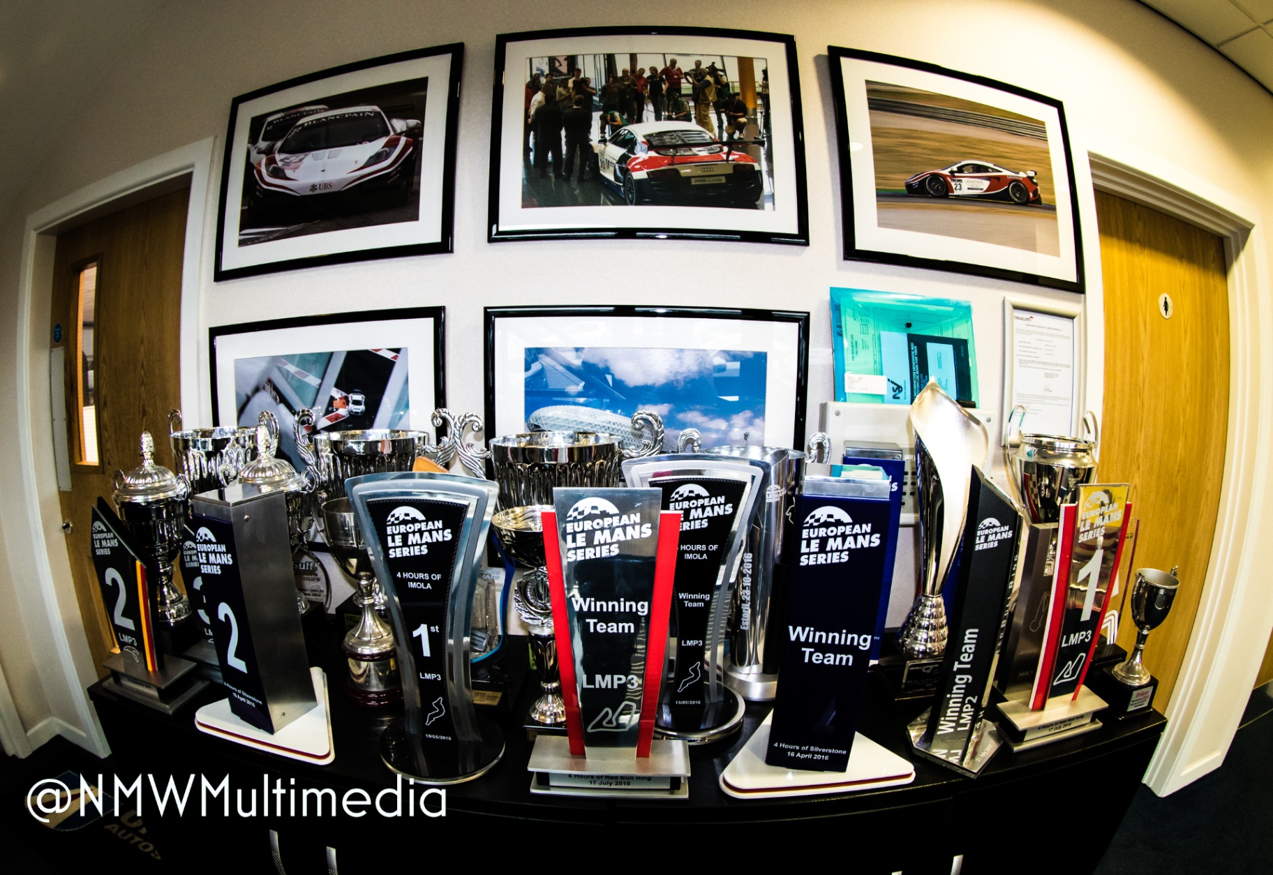A wall of European Le Mans Series trophies — the receipts of a craft pursued for years.